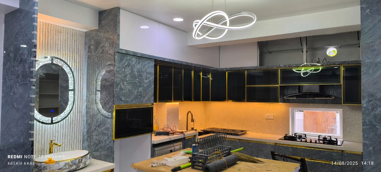 Modern kitchen with black glass cabinets and warm backsplash