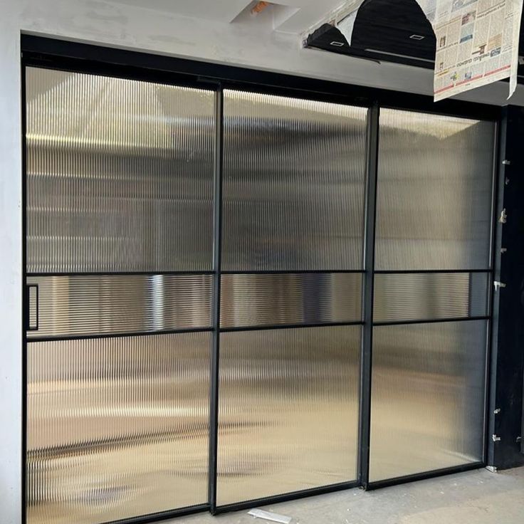 Black framed sliding glass doors with translucent panels